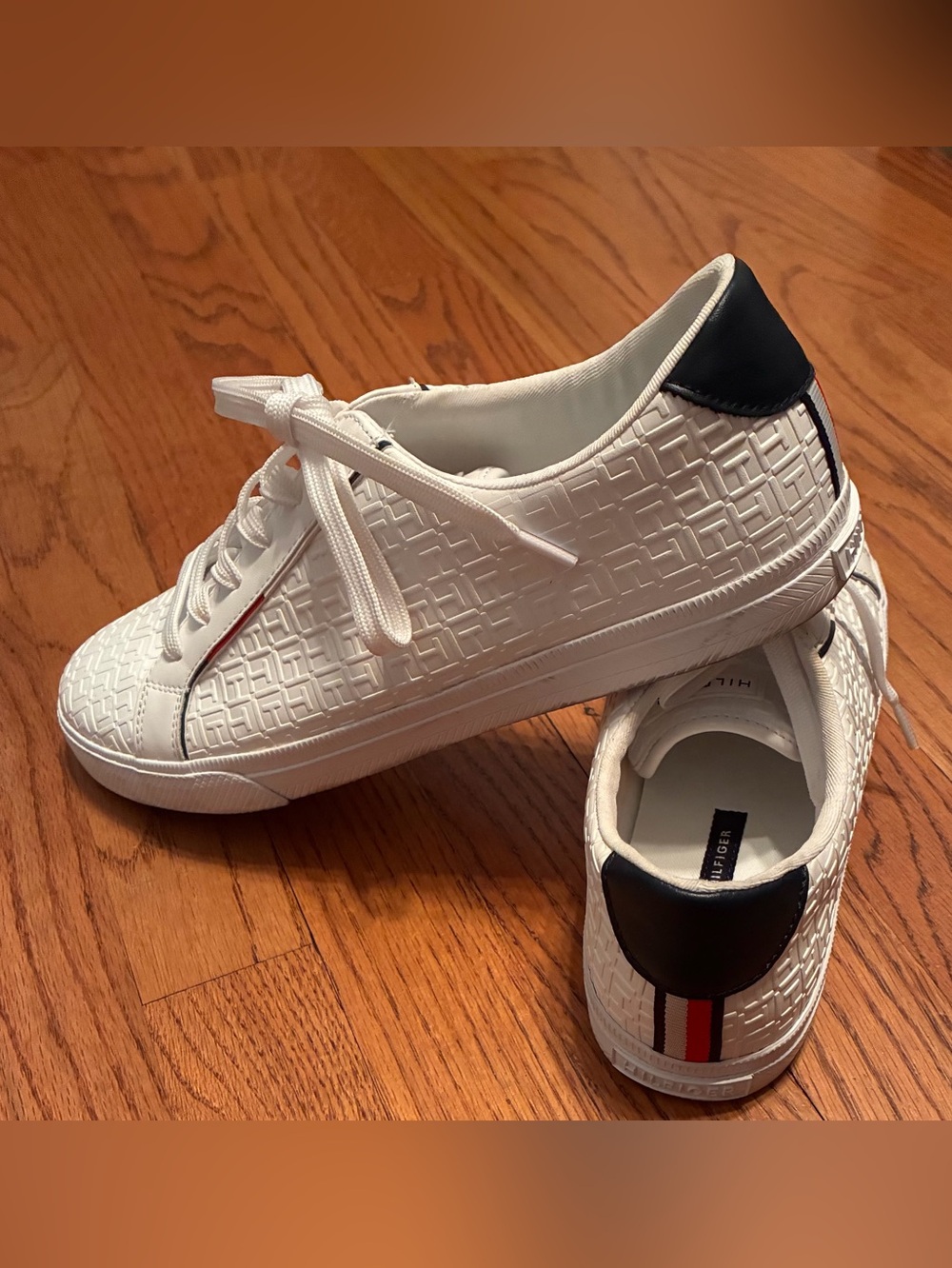 Tommy Hilfiger White Embossed Sneakers with Navy Heel and Red-White-Blue Stripe.